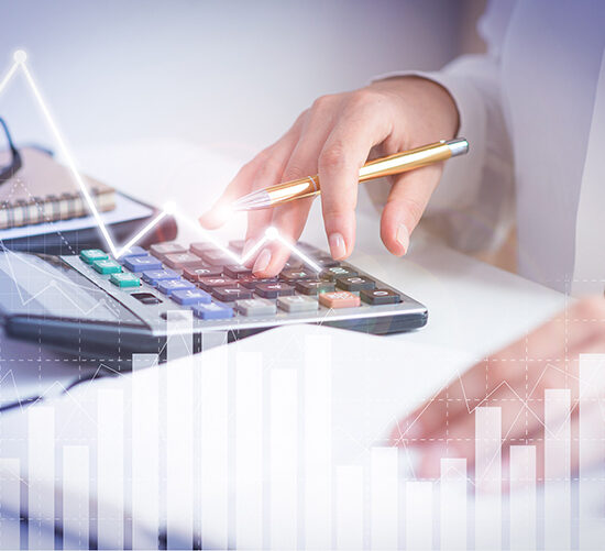Accountant calculating profit with financial analysis graphs Accountant calculating profit with financial analysis graphs. Notebook, glasses and calculator lying on desk. Accountancy concept. Cropped view.